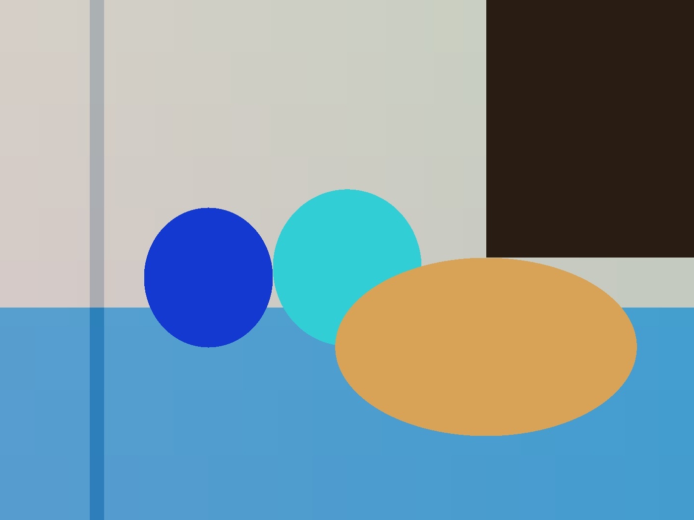 Inverted geometric still life with a blue circle, a cyan circle, and an orange oval on a blue table