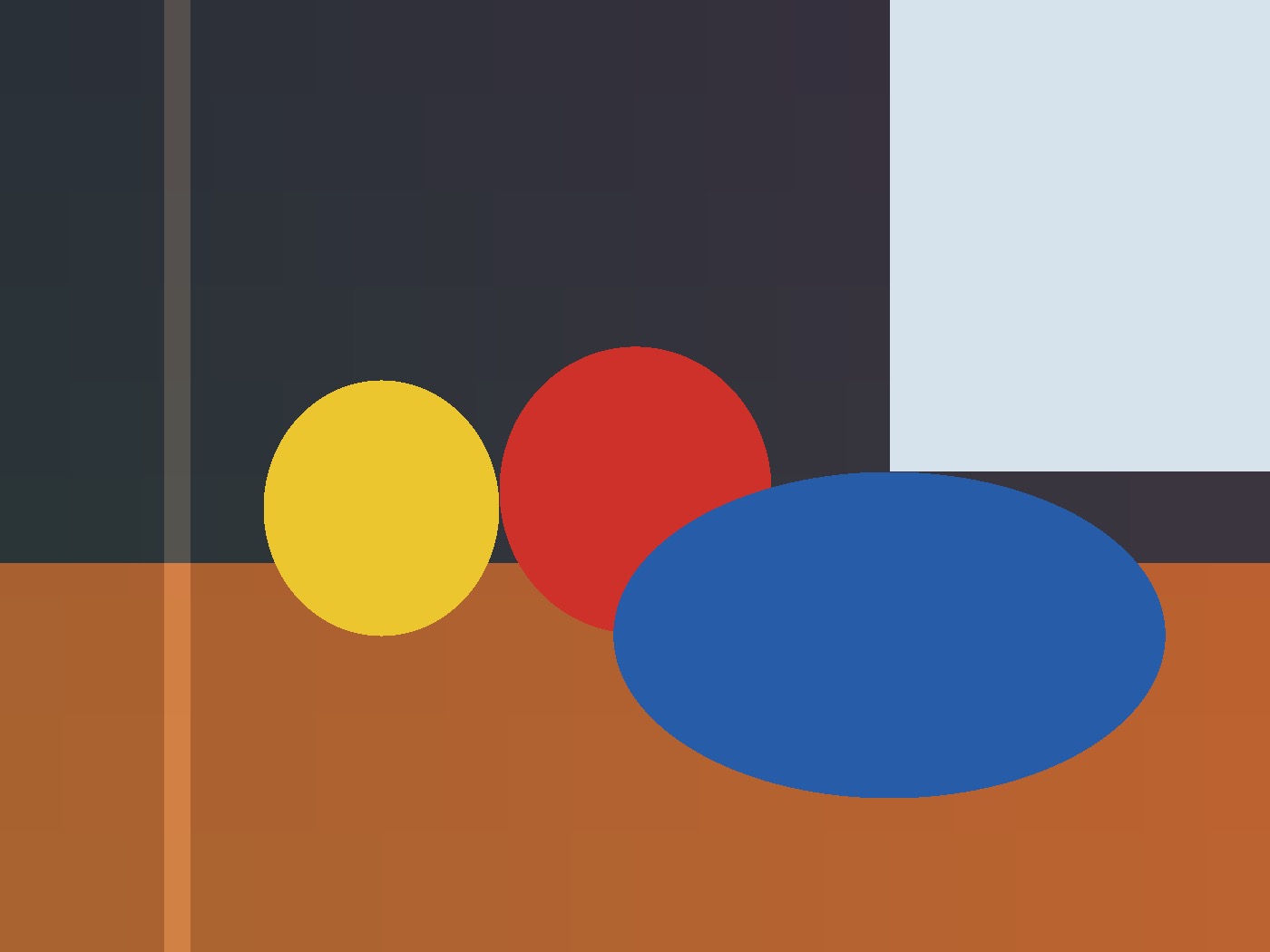 Original geometric still life with a yellow circle, a red circle, and a blue oval on an orange table